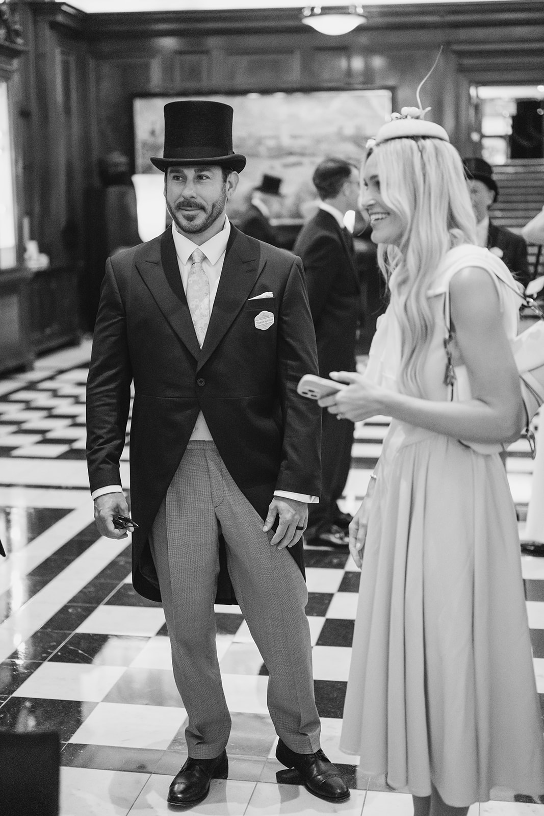 Name badge pinned to morning suit