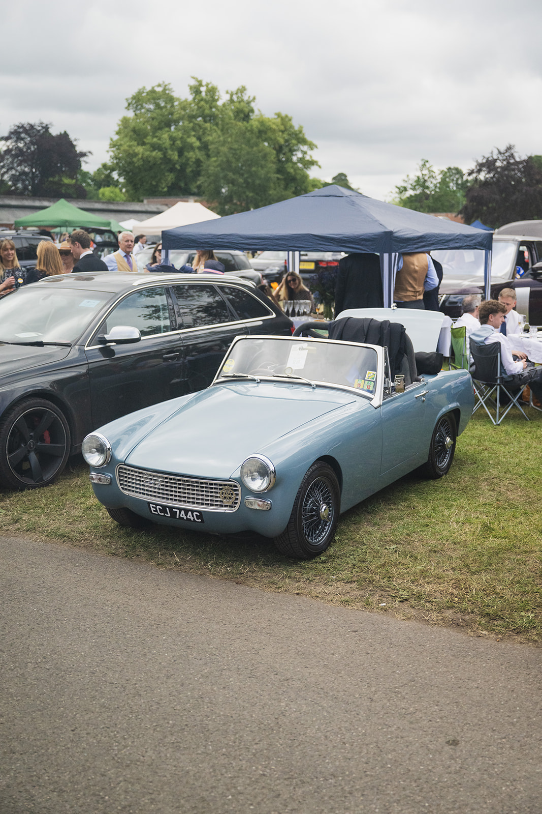 Vintage convertible displayed on event grounds