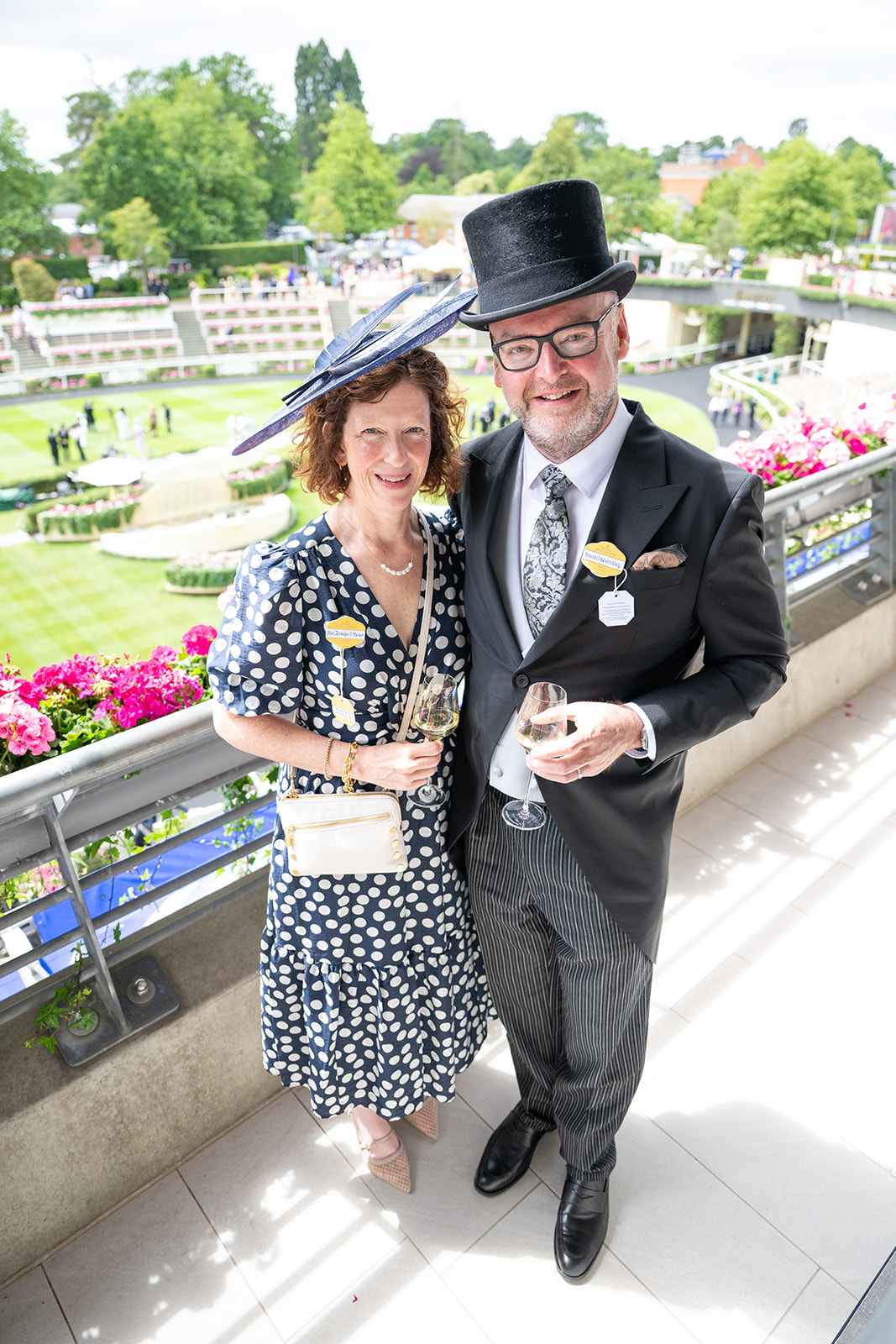 Couple standing beside balcony flowers
