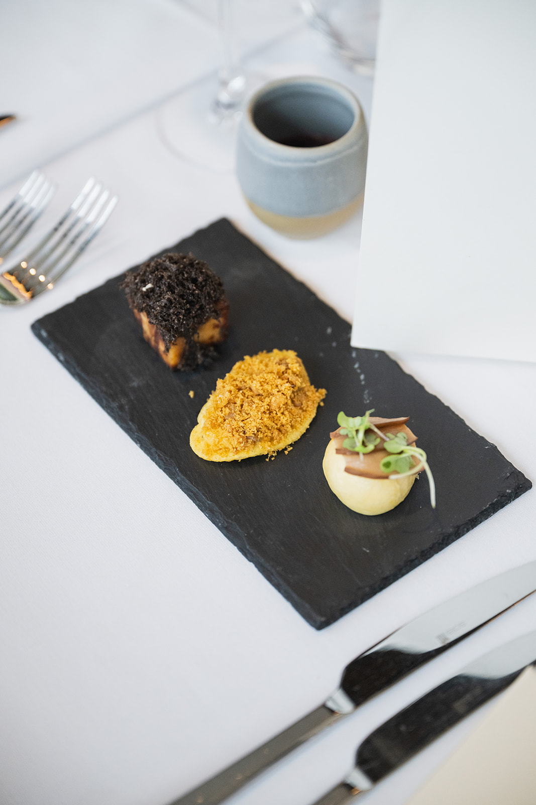 Canapés served on black slate platter