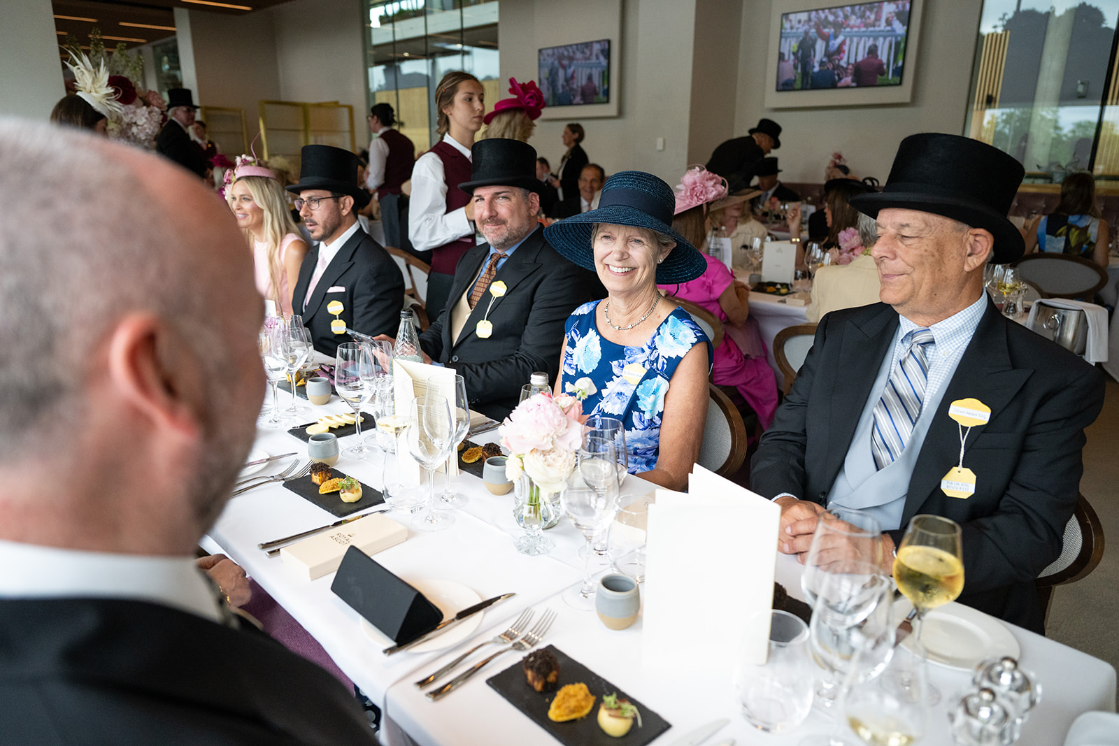 Guests dining beside floor-to-ceiling windows