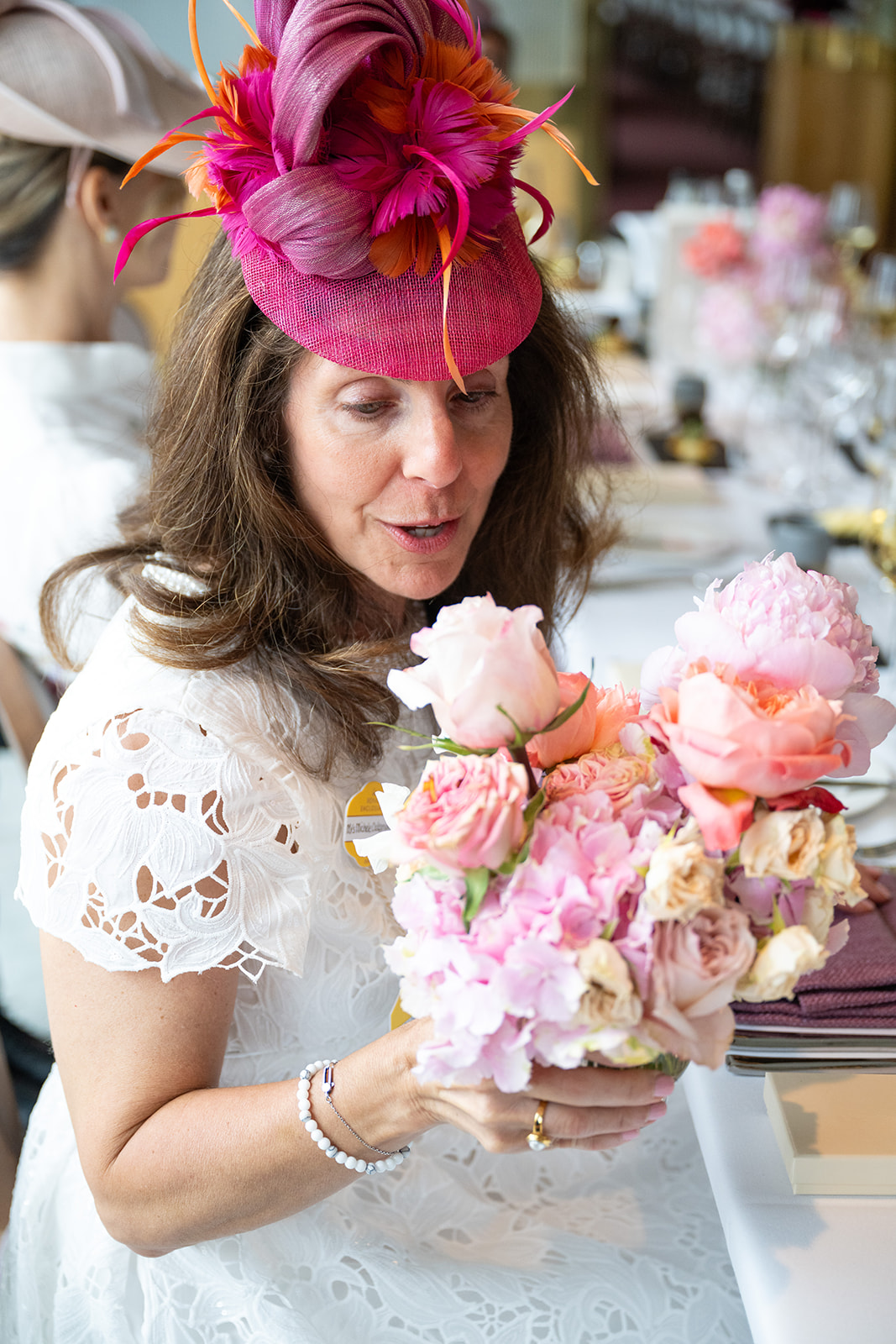 Attendee holding pink floral arrangement