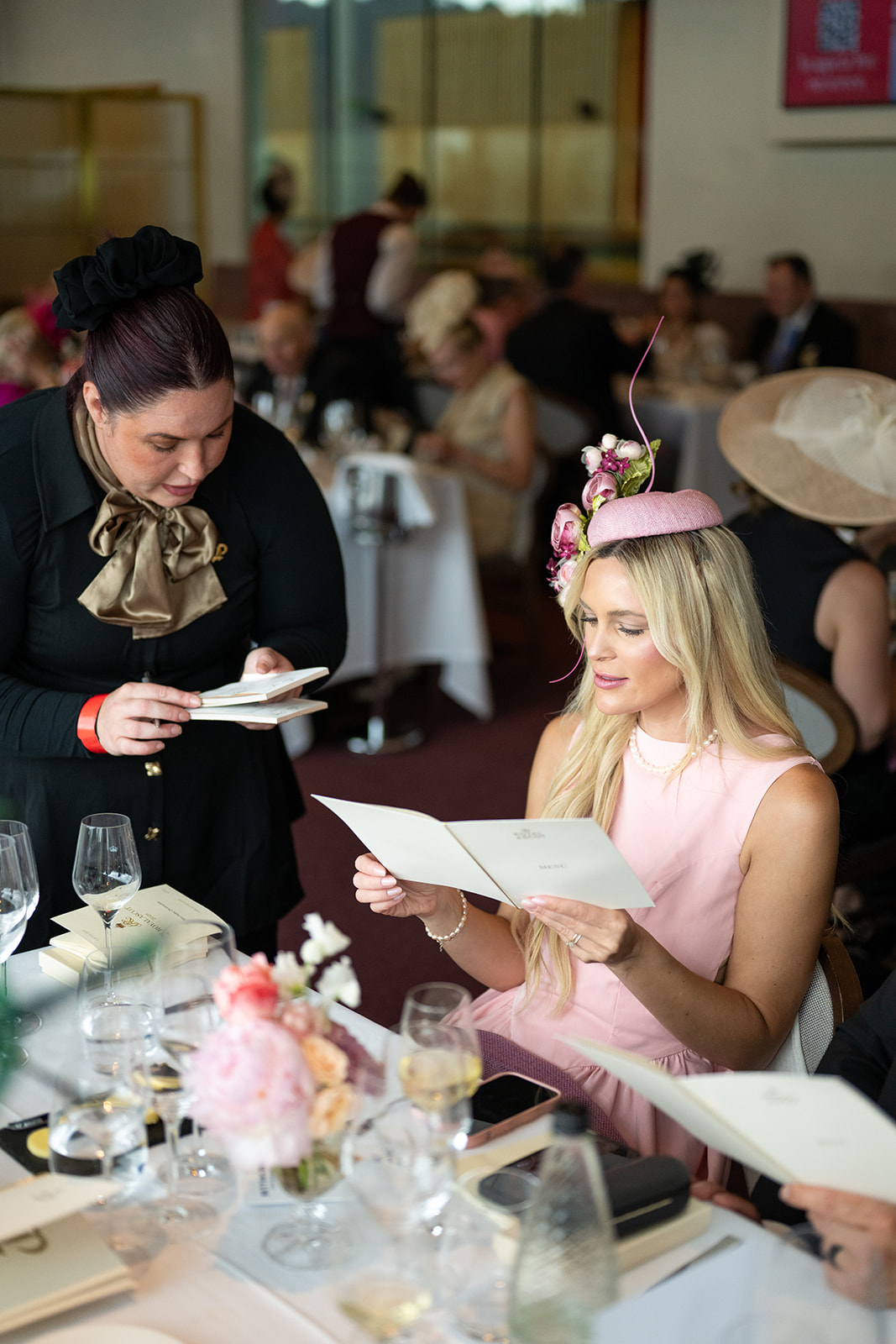 Attendee reviewing menu card at luncheon table