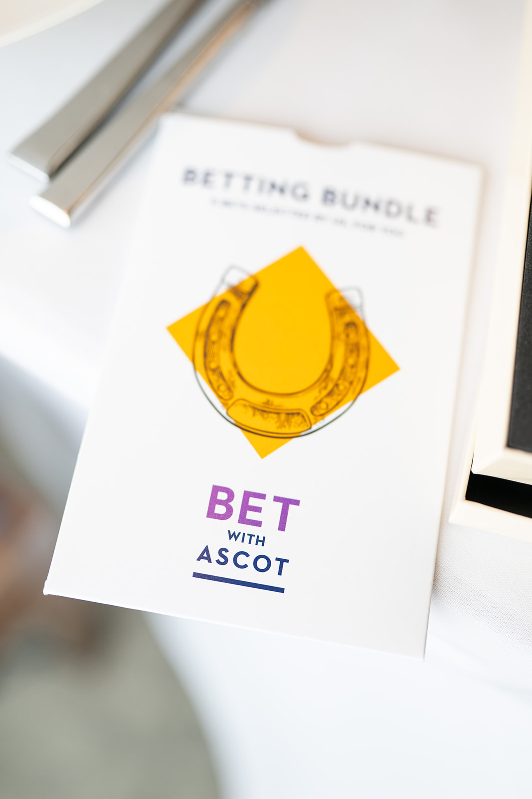 Ascot-themed event card with horseshoe graphic