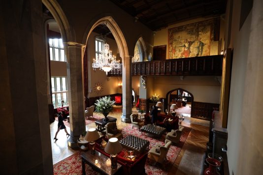 Grand interior lounge with chandeliers and seating.