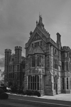 Historic manor building in black and white.