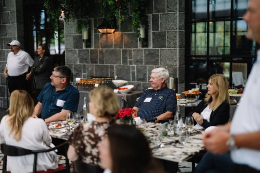 Guests seated at round table during dinner.