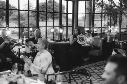 Black and white dining scene with live music.