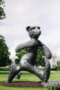 Statue in garden captured in black and white.