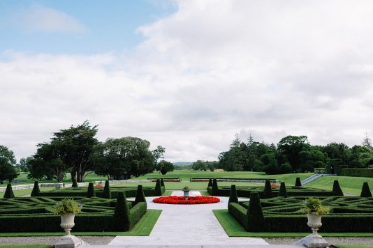 Formal garden with trimmed hedges and pathway.
