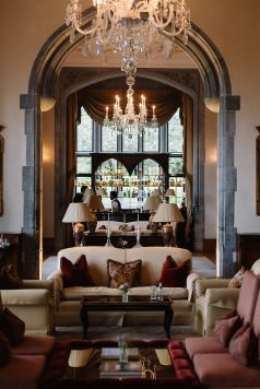 Elegant lounge area with arched doorway and seating.
