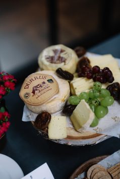 Cheese board with grapes and soft cheeses.