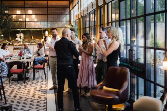 Guests learning to play an instrument dining room.