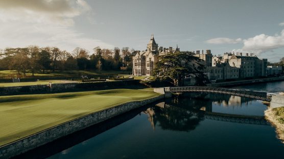 Scenic river view with the manor in the background.
