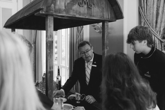 Guests standing under a covered outdoor area.