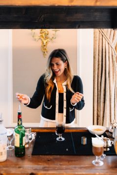Guest preparing a drink at a table.