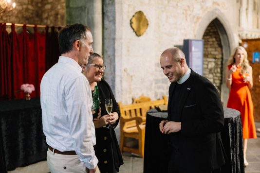 Guests conversing during an indoor reception.