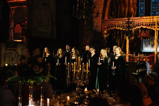 Choir singing by candle light