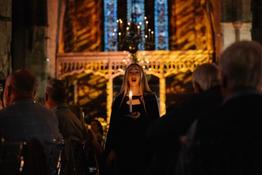 Cathedral event scene with audience and stage.