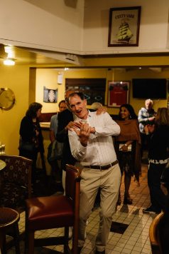 Attendee dancing in indoor venue.