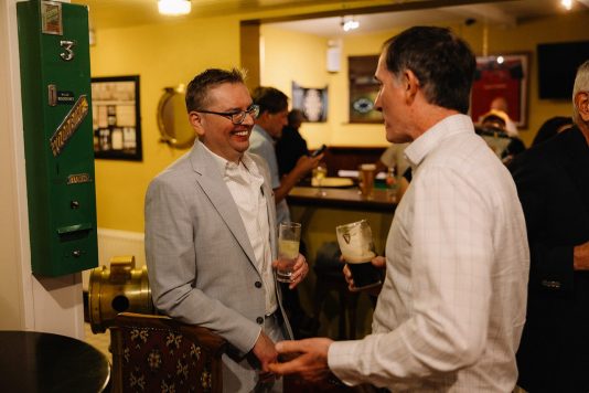 Guests chatting inside a pub setting.