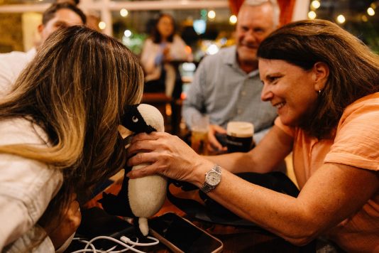Two guests smiling while seated at a table.