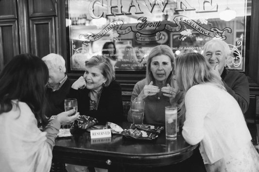 Black-and-white image of guests seated at a table.