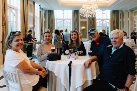 Group seated around a round dining table.