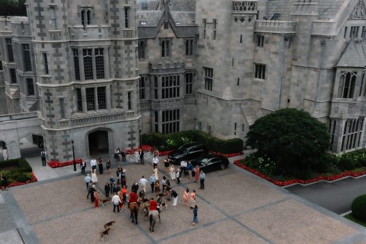 Overhead view of guests gathered outside the manor.