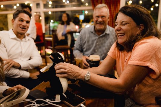 Guests laughing together at a table.