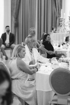 Black-and-white image of guests seated at dinner.