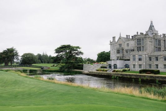 Scenic manor view along a riverbank.