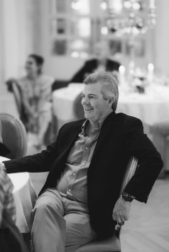 Black-and-white portrait of a seated guest.