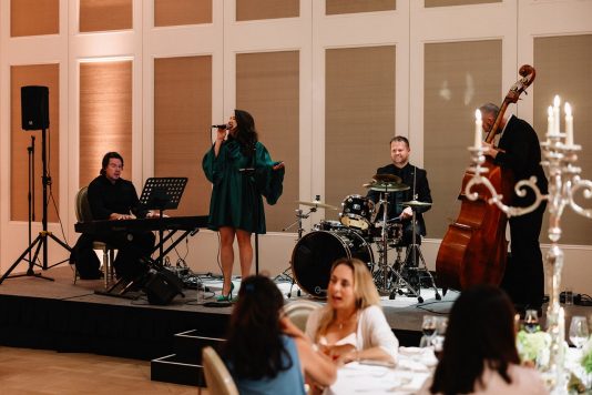 Band performing on a stage indoors.