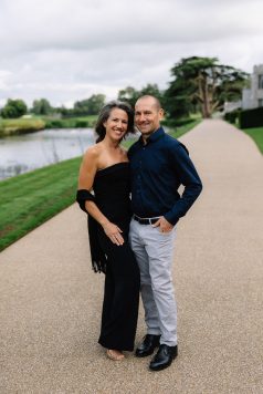Two guests posing together on a walkway.