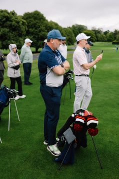 Group of golfers gathered on the course.