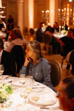 Guest seated at a dinner table indoors.