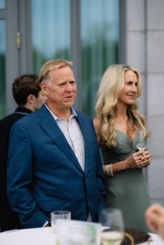 Two guests standing outdoors during an event.