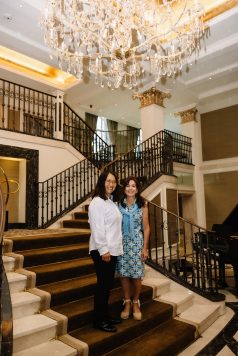 Two guests standing on an indoor staircase.