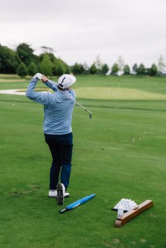 Golfer following through on a swing.