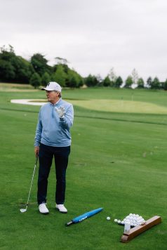 Golfer standing on the fairway.