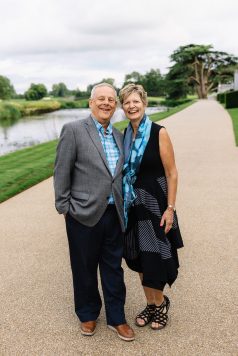 Two guests posing outdoors along a path. 