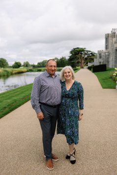 Portrait of two adults on a path by a river at an estate