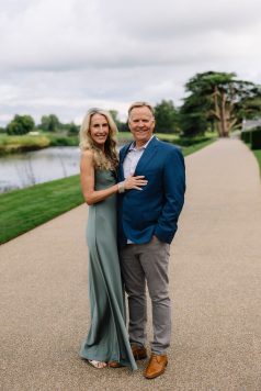 Portrait of two adults on a pathway with estate grounds in background