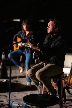 Acoustic musician performing at night