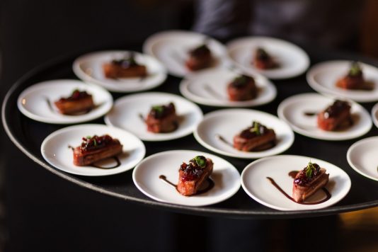 Rows of plated appetizers on tray