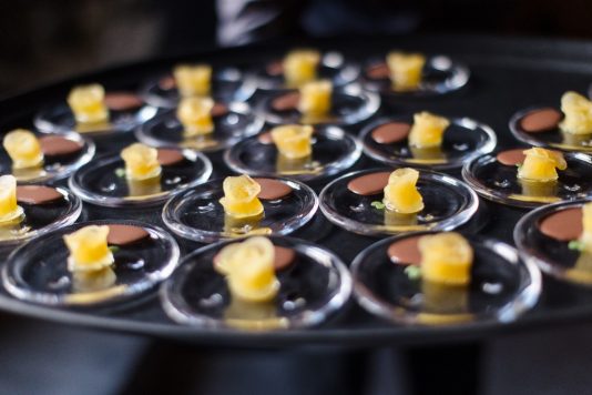 Servers holding appetizer cones