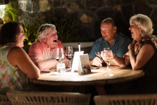 Guests dining at an outdoor table