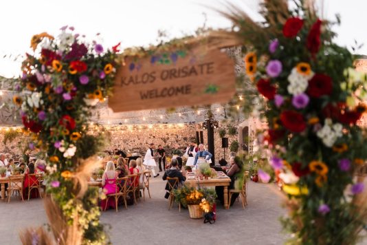 Floral welcome sign at outdoor event