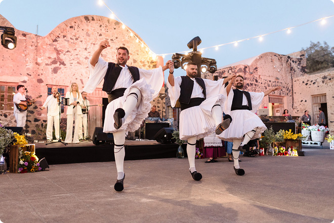 Performers dancing in traditional attire during an outdoor festival event